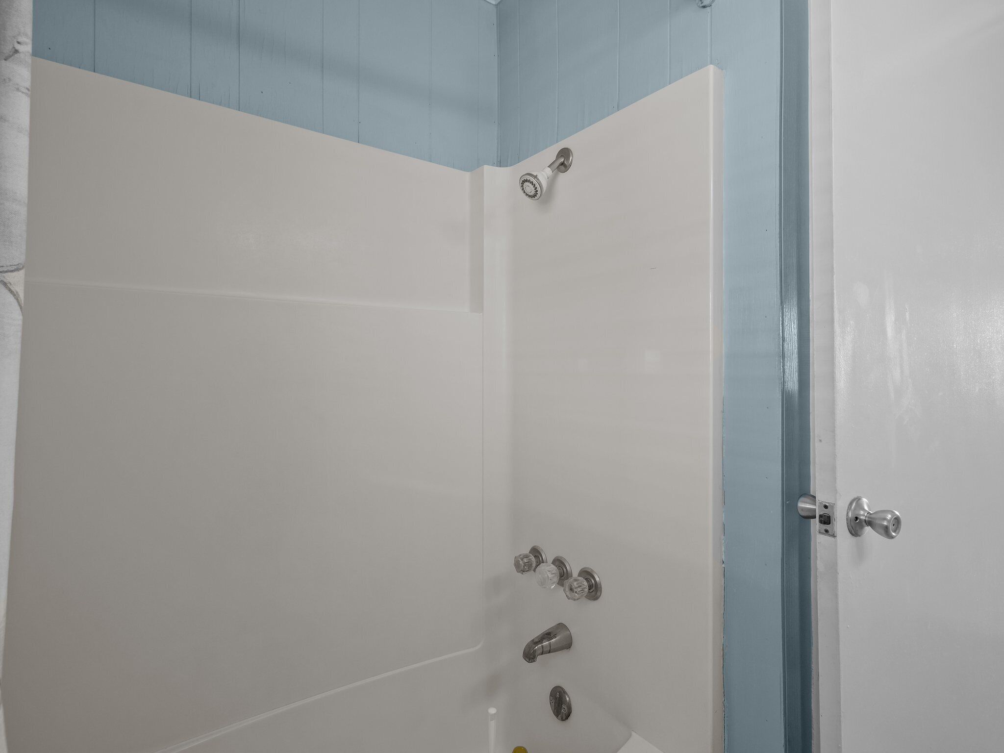 A bathroom with a shower, a toilet, and a sink.