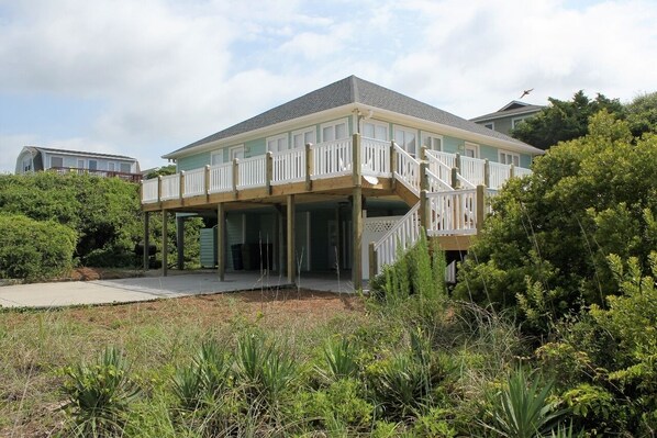 A two-story house with a balcony, surrounded by greenery. - POOL and beach access steps away from driveway! (Emerald Isle)