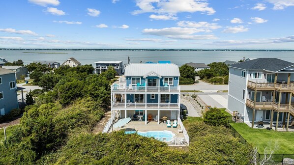 A large, multi-story house with a pool and a view of the sea. - Ocean and Sound Views - Pet Friendly! (Emerald Isle)