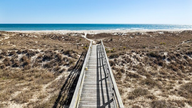 A wooden boardwalk leading to a beach with dunes and a clear blue sky. - Point Emerald E305 - 3BR - Near "The Point" and views of Bogue Inlet (Emerald Isle)