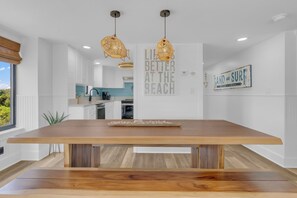Enjoy cooking in this well-equipped kitchen with a large island and bench, featuring a view of the adjacent living area.