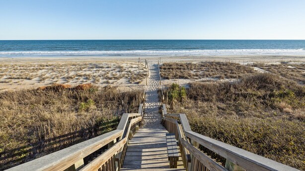 A wooden boardwalk leading to a beach with a clear view of the ocean. - Sound of the Sea 203N - 2BR Condo w/ Pool! (Emerald Isle)