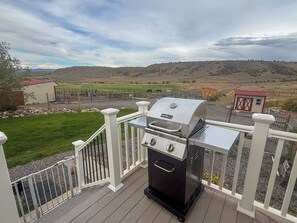 A barbecue grill on a deck with a view of a hilly landscape. - Forever Family Farm Hunters Welcome Mountain Views (Montrose)