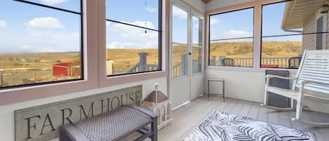 Relax on the enclosed porch with awesome views
