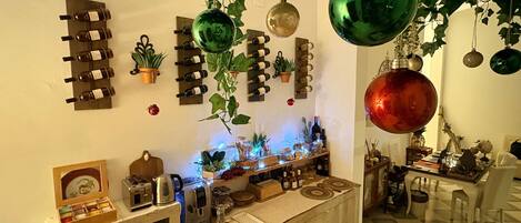A room with a wine rack, potted plants, and a checkered floor.