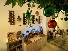 A room with a wine rack, potted plants, and a checkered floor.