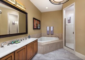 Bathroom features a bathtub, separate shower, and double sinks.
