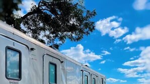 A row of mobile homes with external stairs and a shower sign.