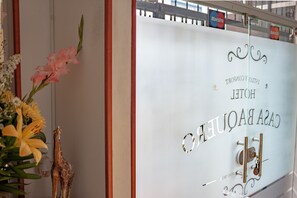 A hotel room with a frosted glass door, a keycard slot, and a decorative giraffe figurine.