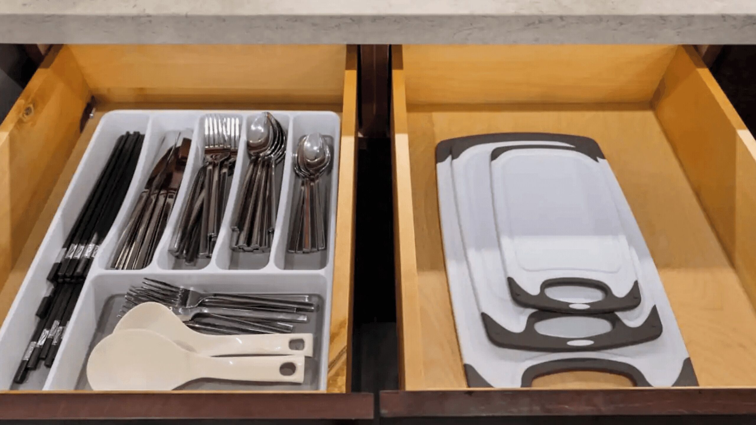 A drawer with utensils and a spatula.
