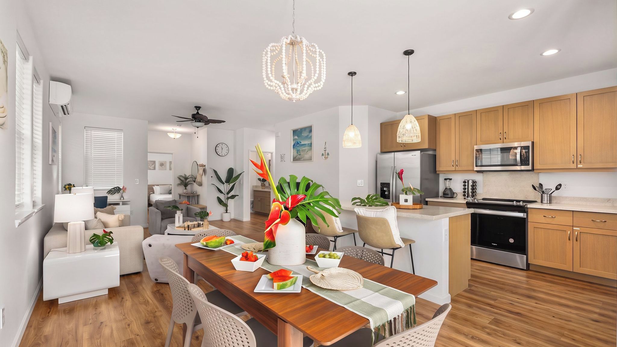 A modern kitchen with wooden cabinets, a stainless steel refrigerator, and a microwave.