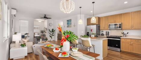 A modern kitchen with wooden cabinets, a stainless steel refrigerator, and a microwave.