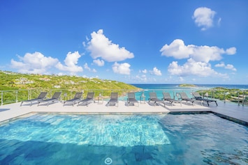 One large heated pool on the main level. Second pool on the lower level, next to bedroom 5. Deckchairs . Magnificent view on the bay of Marigot.