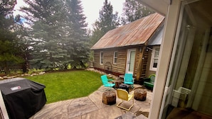 A patio with stone flooring, a barbecue grill, and outdoor furniture.