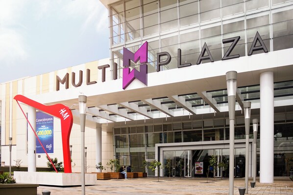 A modern building with a large sign reading "MULTIPLAZA".