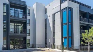 A modern building with multiple balconies and large windows. - East Nashville Luxury Condo~Rooftop Deck~Game Room~King Suite~Walk-In Showers (Nashville)