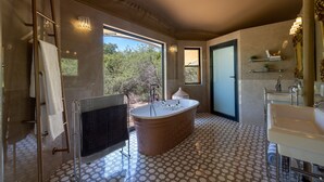 A modern bathroom with a freestanding bathtub, a separate sink, and a glass shower enclosure. - Canvas Villa with pool (Hoedspruit)