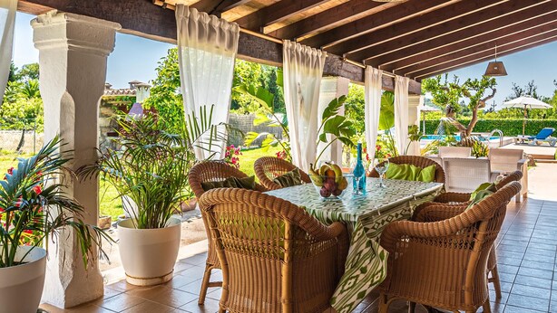 An outdoor patio with wicker furniture, a table with a patterned tablecloth, and potted plants. - XIM ( Angels ). Nice villa within walking distanace to Pollensa (Pollensa)