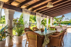 An outdoor patio with wicker furniture, a table with a patterned tablecloth, and potted plants. - XIM ( Angels ). Nice villa within walking distanace to Pollensa (Pollensa)