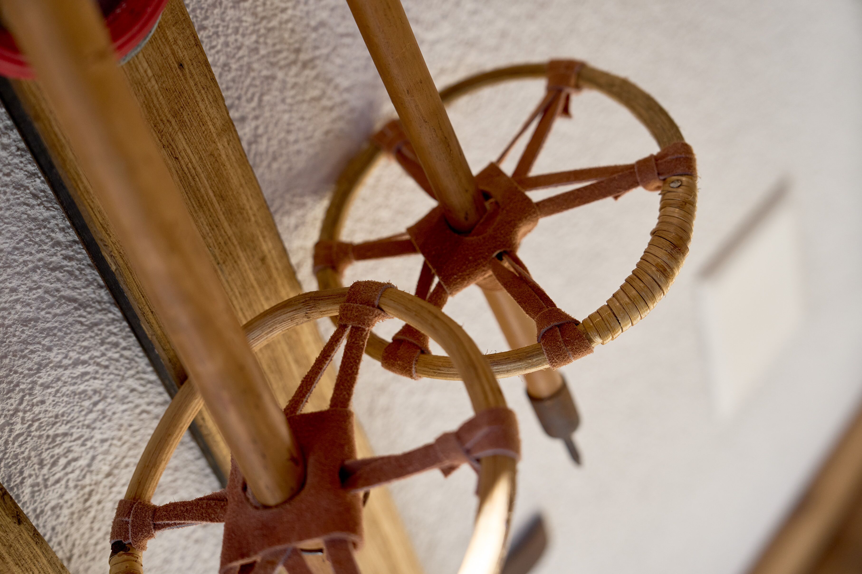 A close-up of a wooden and leather wheel mechanism.