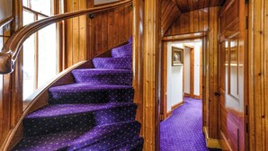 A wooden staircase with purple carpeted steps leading to a door. - 3 bedroom accommodation in Pitlochry (Pitlochry)