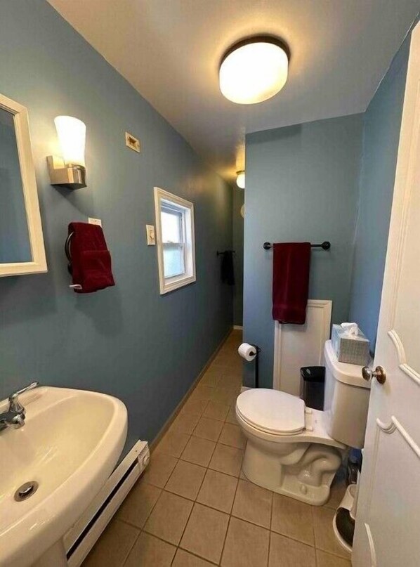 A bathroom with a sink, toilet, and a window. - Charming, cheerful, comfortable, centrally located, and walkable!
(Pittsburgh)