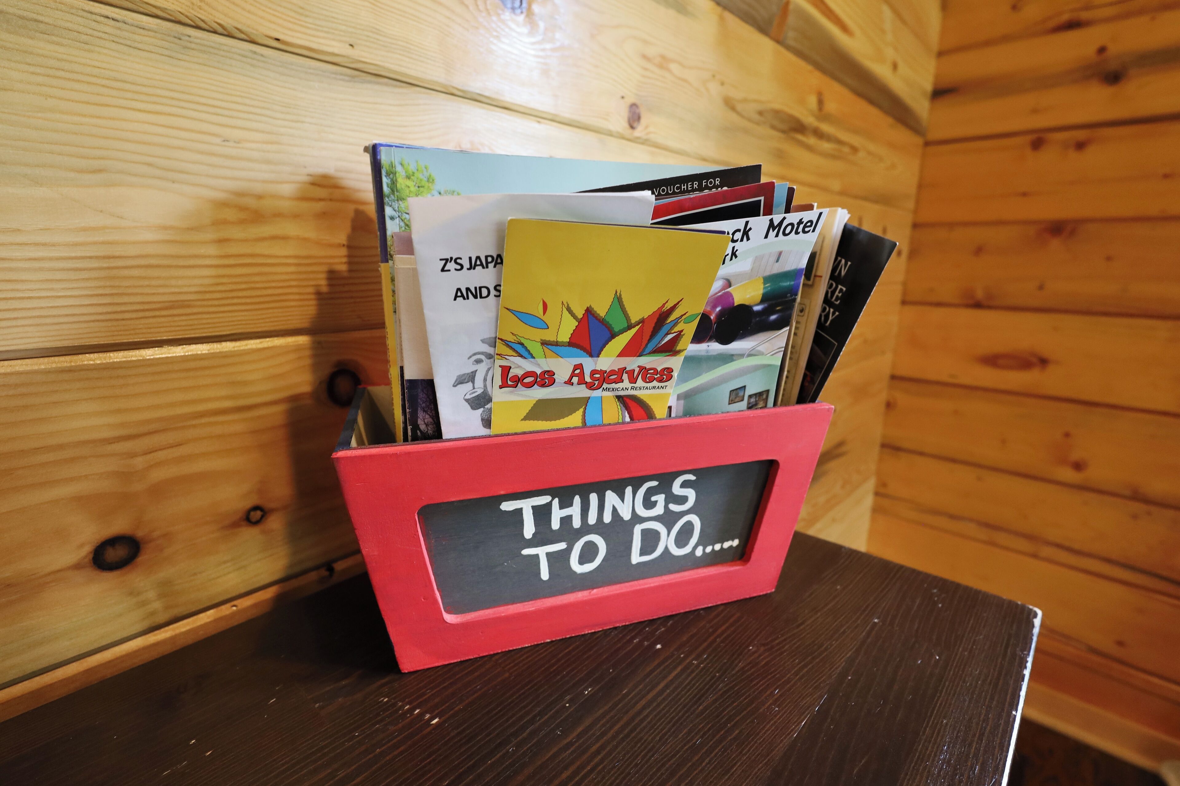 A red folder labeled "THINGS TO DO" with various travel brochures and a Los Angeles brochure.