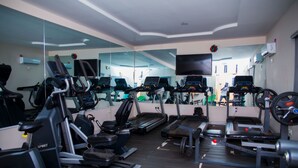 A gym with multiple treadmills, stationary bikes, and weight machines. - GPinnacle Suites (Ilorin)