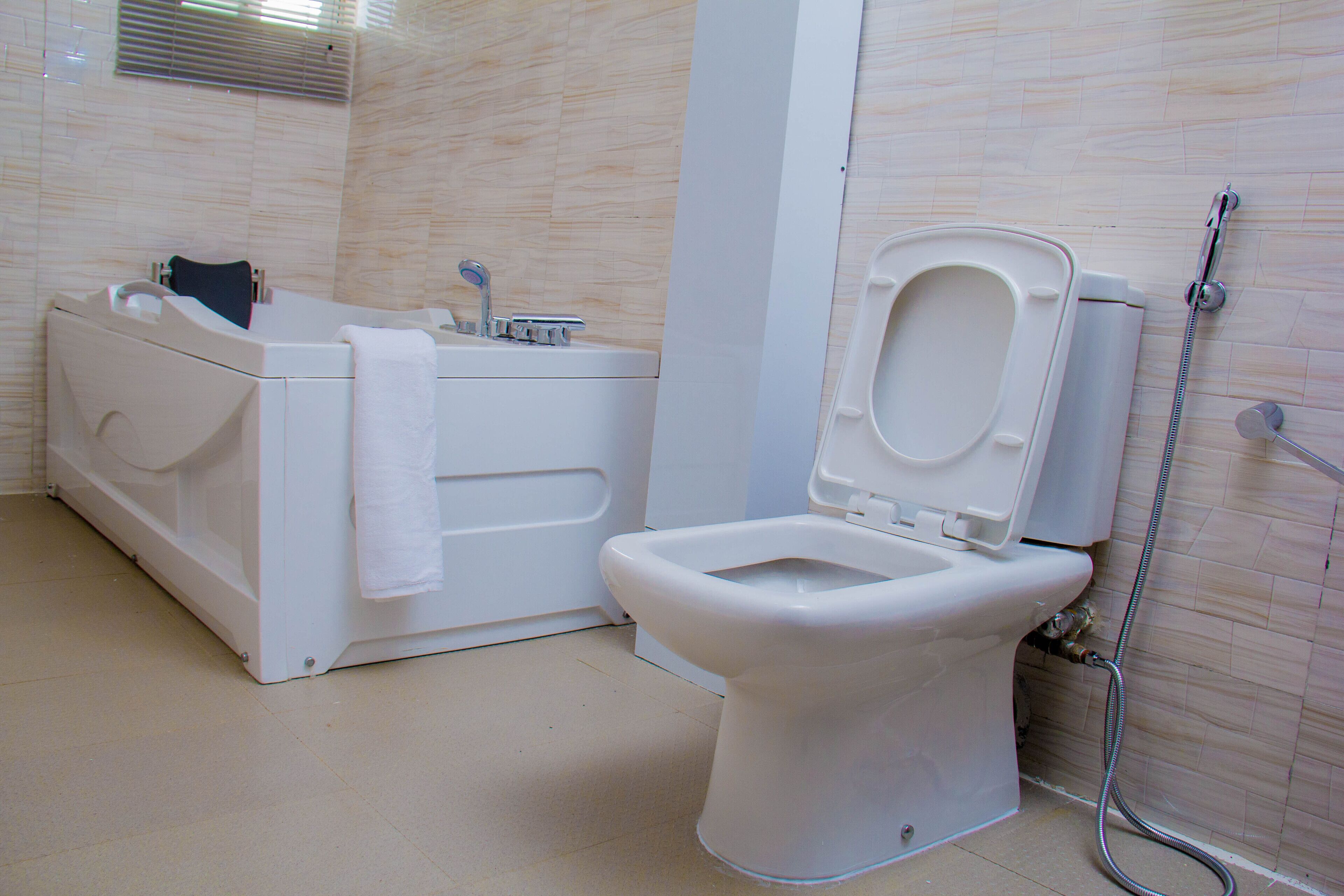 A bathroom with a bathtub, toilet, and shower.