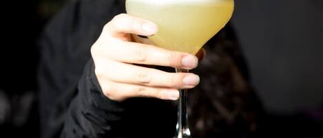 A person holding a cocktail glass.