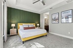 A bedroom with a bed, nightstands, a dresser, a mirror, and two posters on the wall. - 3 king suites + private heated pool, just steps to resort amenities. (Kissimmee)