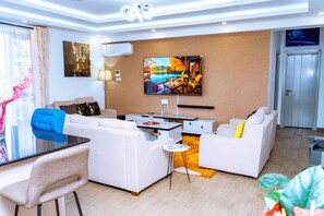 Relax in a comfortable seating area with a sofa set and armchair, perfect for socializing or enjoying a casual meal.