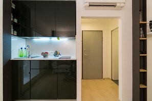 A compact kitchen with a modern design, a built-in stove, and a small countertop.
