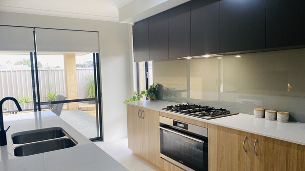 A modern kitchen with a large island, built-in oven, and stainless steel appliances. - New 5 Bedroom Home 1km from the Beautiful Busselton Beaches  (Geographe)