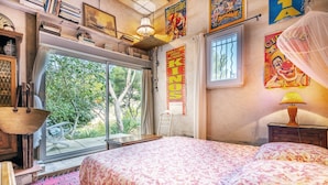 A bedroom with a large bed, a window, a ladder, and a poster on the wall. - Holiday Home 'Villa Calanques' with Sea View, Private Terrace and Wi-Fi (Ensuès-la-Redonne)