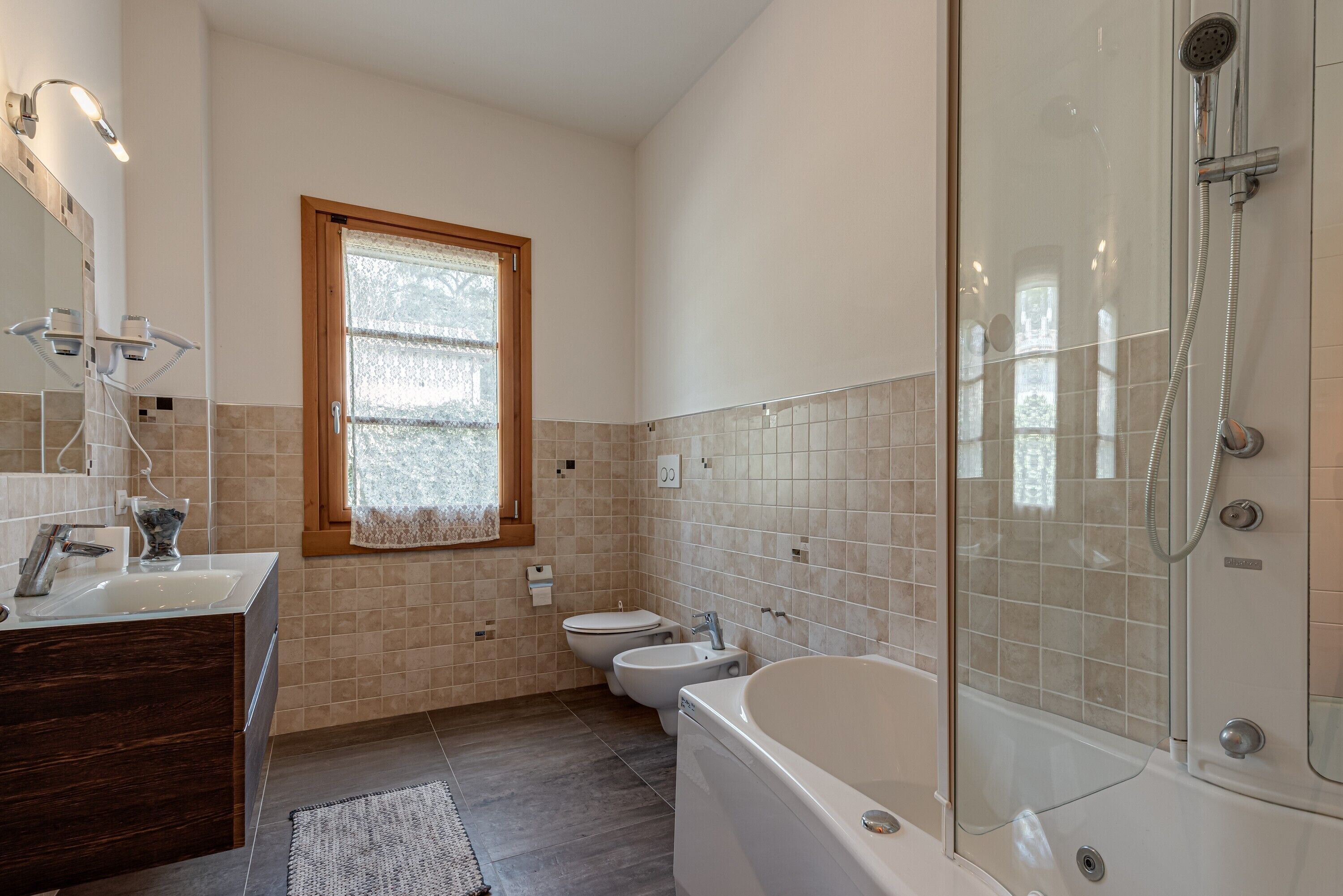A bathroom with a bathtub, toilet, and sink.
