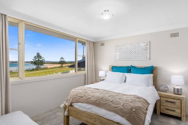 The light and airy first bedroom offers a queen-size bed as well as stunning ocean views.
