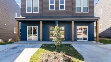 A modern building with a flat roof, large windows, and a central entrance.