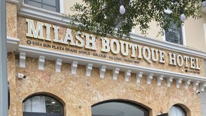 The exterior of Milash Boutique Hotel with a stone facade, arched windows, and a reception area visible through the open door. - Milash Boutique Hotel (Bai Chay)