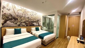 A hotel room with two beds, a wooden floor, a glass shower, and a wooden door. - Milash Boutique Hotel (Bai Chay)