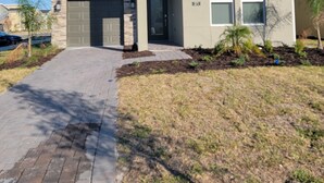 A modern two-story house with a garage, a front entrance, and a well-maintained lawn.
