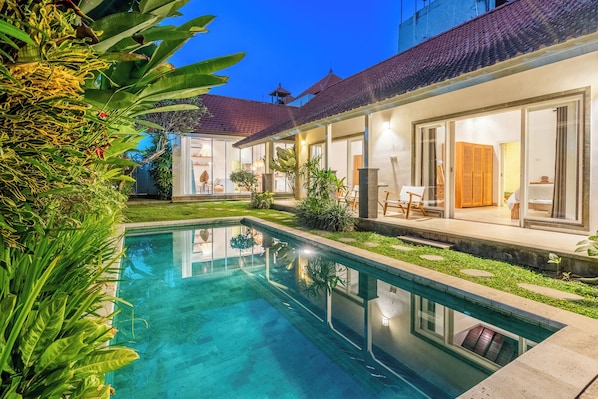 A modern house with a swimming pool, surrounded by lush greenery and a well-maintained lawn. - Jungle Amaranth Villa Canggu - Exclusive 3BR Retreat with Pool, Modern Amenities and Top Location (Canggu)