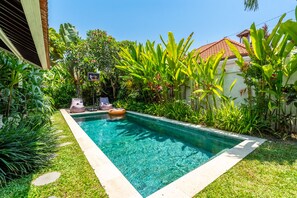 A rectangular swimming pool surrounded by lush greenery and a tiled roof structure. - Jungle Amaranth Villa Canggu - Exclusive 3BR Retreat with Pool, Modern Amenities and Top Location (Canggu)