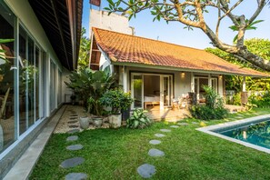 A house with a tiled roof, a swimming pool, and a garden with stepping stones. - Jungle Amaranth Villa Canggu - Exclusive 3BR Retreat with Pool, Modern Amenities and Top Location (Canggu)