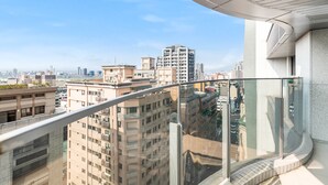 A high-rise building with a curved glass balcony overlooking a cityscape. - High Floor New Bldg 5★ Ximending, Stunning Views (Taipei City)