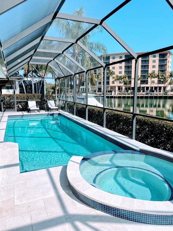 Outdoor pool, a heated pool - Discover Serenity at Camp Joy: A Luxurious 3BR Waterfront Retreat 5min to beach! (Marco Island)