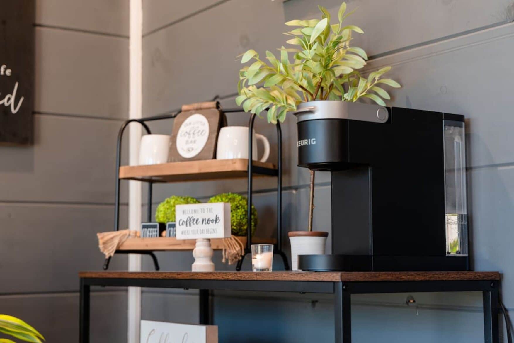A coffee machine on a shelf with a sign that reads "Welcome to the coffee nook."