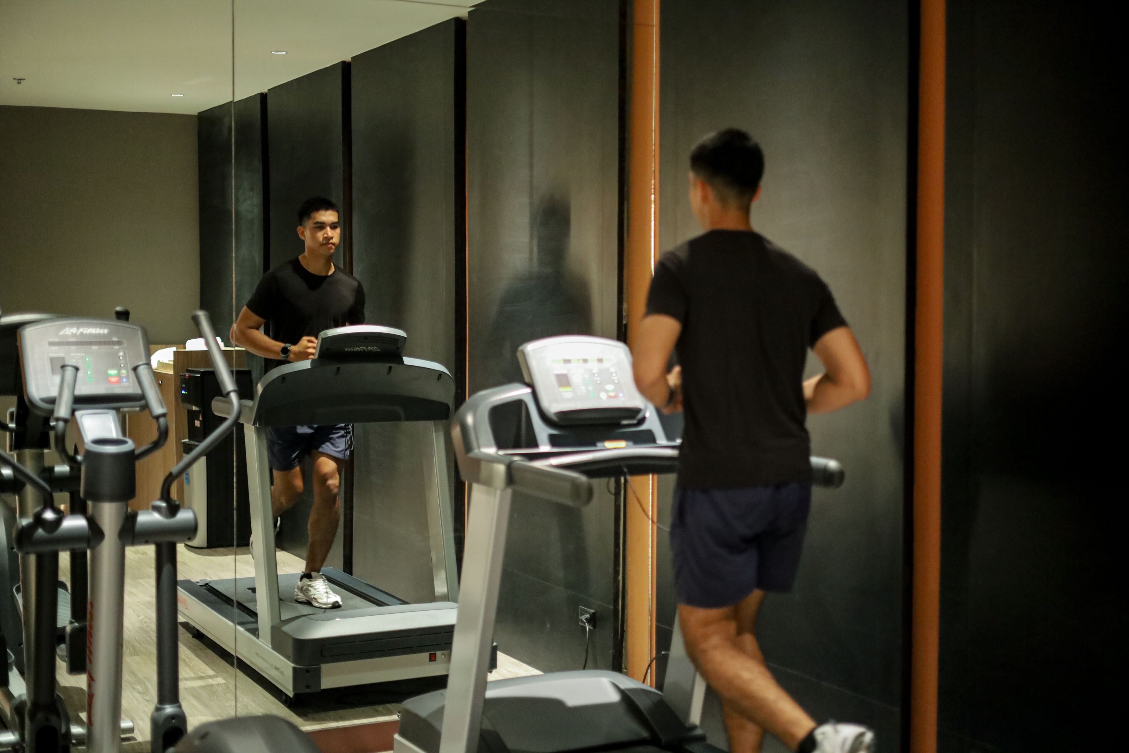 A gym with treadmills and exercise equipment.
