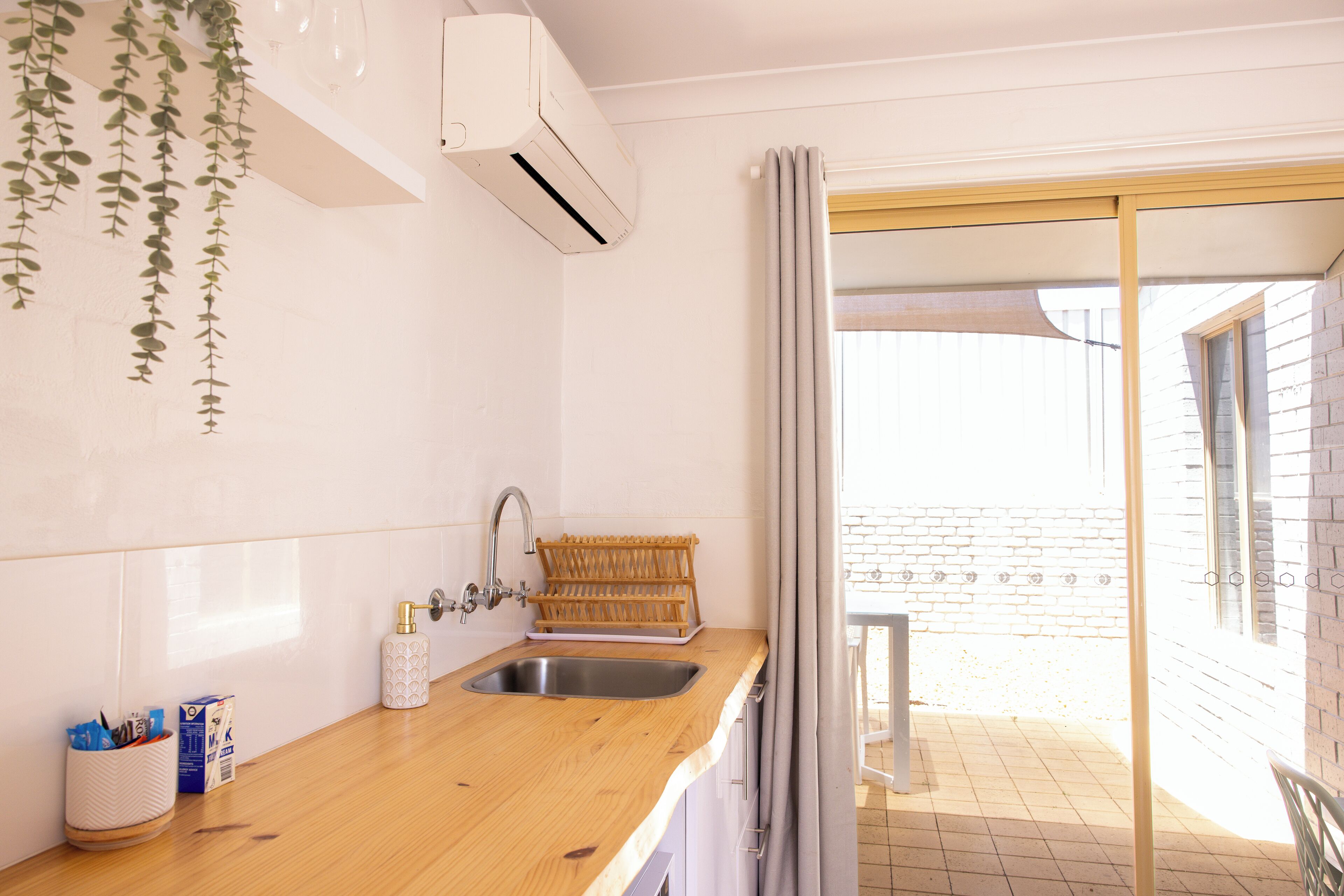 Fridge, electric kettle, cleaning supplies