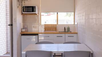 Fridge, electric kettle, cleaning supplies